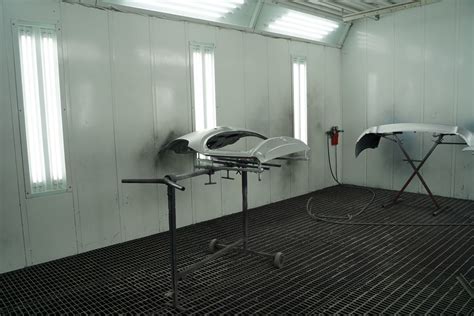 Vaizdinė iliustracija: automobilis, dažomas specializuotoje dažymo kameroje su profesionalia įranga.