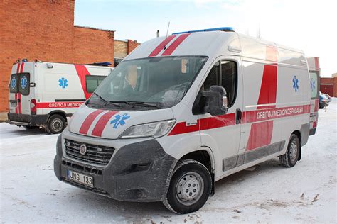 Teminė nuotrauka su skubančiu specialiuoju transportu (greitosios pagalbos, policijos ar gaisrinės automobiliu) ir aplinkiniais automobiliais, duodančiais kelią