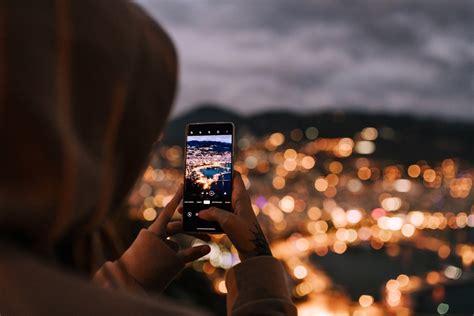 Teminė nuotrauka su išmaniuoju telefonu, rodančiu navigaciją kelyje