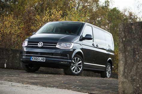 The new VW Caravelle in an urban setting, showcasing its modern design and passenger transport capabilities