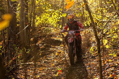 Motokroso sportininkas su visa apsaugine apranga ir šalmu