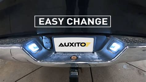 Photo of a new license plate bulb, screwdrivers, and gloves