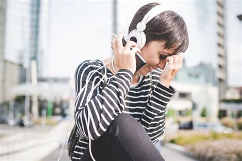 Motociklininkas su šalmu klausosi muzikos