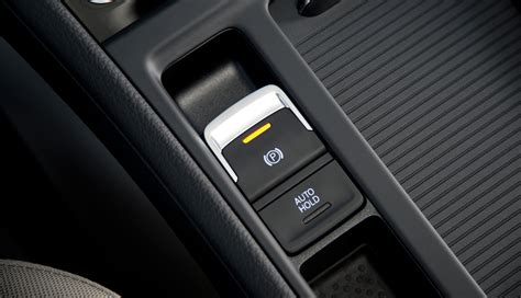 image of an electronic parking brake button on a car's center console