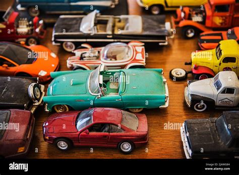Thematic photo of a child playing with toy cars, or a vintage collection of model cars.