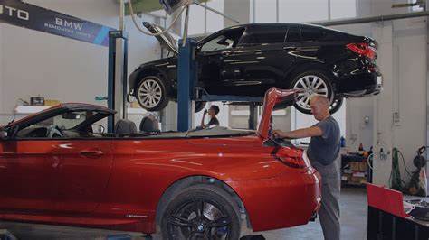 BMW ir MINI autoservisas Vilniuje, mechanikas dirbantis prie automobilio