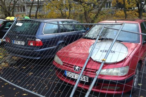 Teminė nuotrauka: apgadintas automobilis prie tvoros