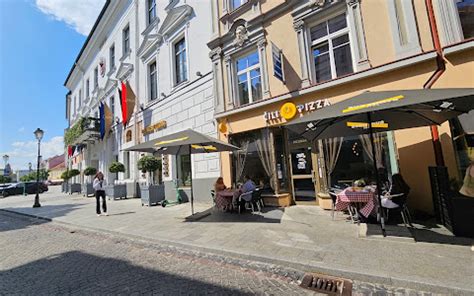 Vaizdas į Piotrkowska gatvę Lodzėje su kavinių ir parduotuvių vitrinomis