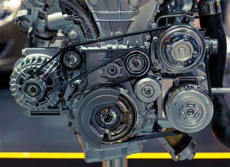 Thematic photo of car engine compartment with alternator belt visible