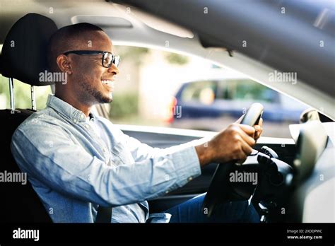 Thematic photo of a person happily driving a new car, symbolizing comfort and mobility