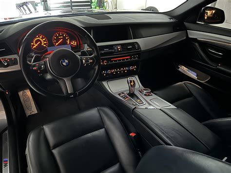 Thematic photo of a BMW F10 interior with cream leather seats