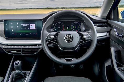 Interior shot of a Skoda Octavia (5E) showing the dashboard, infotainment screen, and spacious cabin.