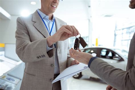 Thematic photo of a satisfied customer receiving car keys, possibly at a dealership offering flexible financing options.