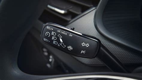 A close-up of the SOS, Info, and Breakdown assistance buttons in a Skoda Octavia