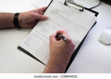 Photo of a person filling out a tax form or questionnaire