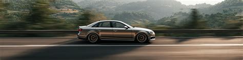 The Audi A4 B8 car model on a road, with a transparent overlay showing the different types of automatic transmissions available for it (Multitronic, S tronic, Tiptronic) and their key characteristics.