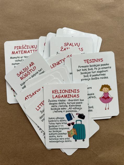 Paveikslėlis, iliustruojantis žaidimo lentą su traukiniais ir maršrutais, bei žaidimo korteles.