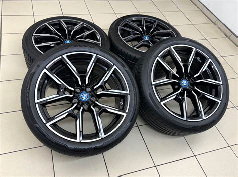 BMW automobilis su juodais ratlankių dangteliais, artimas planas