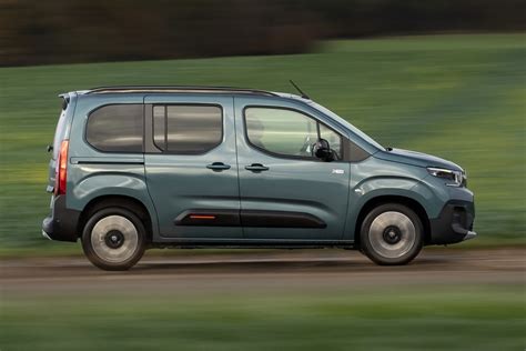 Citroën Berlingo modelio iliustracija su atviromis slankiojančiomis durimis, demonstruojanti erdvų saloną.