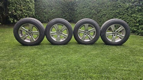 Automobilio ratai su žieminėmis padangomis ant apsnigto kelio