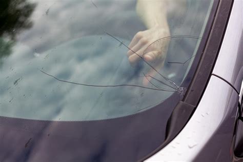 Photo of a car windshield with a visible crack or chip