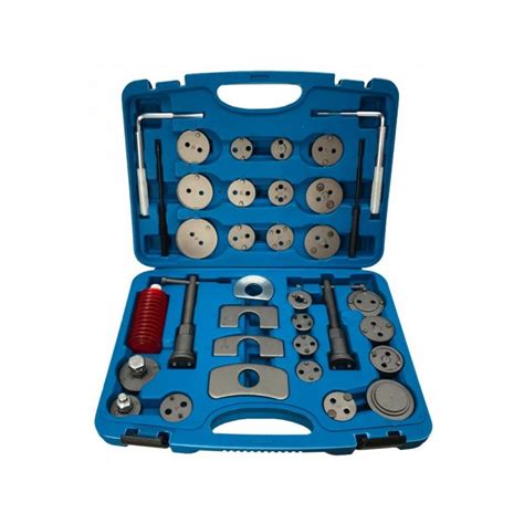 detalus galinio stabdžių suporto ardymo vaizdas su įvairiomis dalimis ir remontinio komplekto elementais