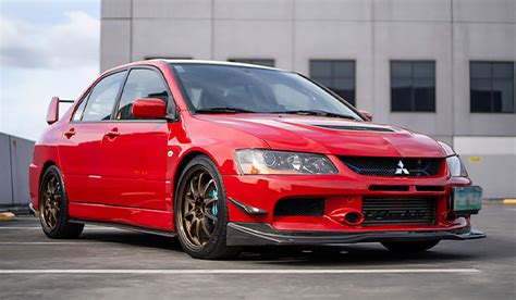 automobilio „Mitsubishi Lancer Evo IX“ nuolaužos po avarijos laukuose