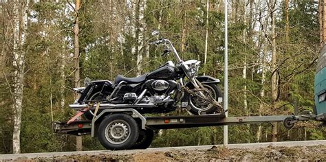 Priekabininkas motociklo su priekaba atlieka akrobatinį manevrą