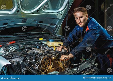 mechanic working on a car engine