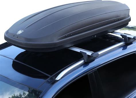Photo of a car with roof racks and a roof box on top