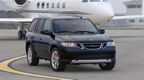 Saab 9-5 su įjungtomis priekinėmis žibintų šviesomis tamsoje, pabrėžiant 
