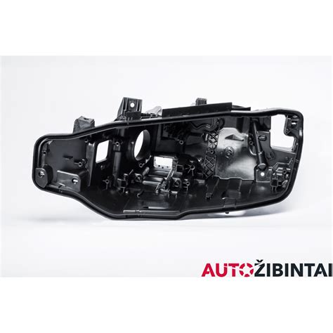 Išardyto Opel Astra H priekinio žibinto korpusas, kuriame matomas modulis ir vidinės dalys