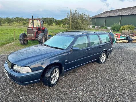 Volvo V70 automobilis su pakeltu priekiu ir nuimtu ratu, rodomas priekinio guolio keitimo procesas