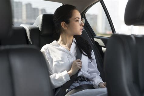 Tematinė nuotrauka: besišypsantys žmonės sėdintys nuomotame automobilyje su gražiu Lietuvos kraštovaizdžiu fone